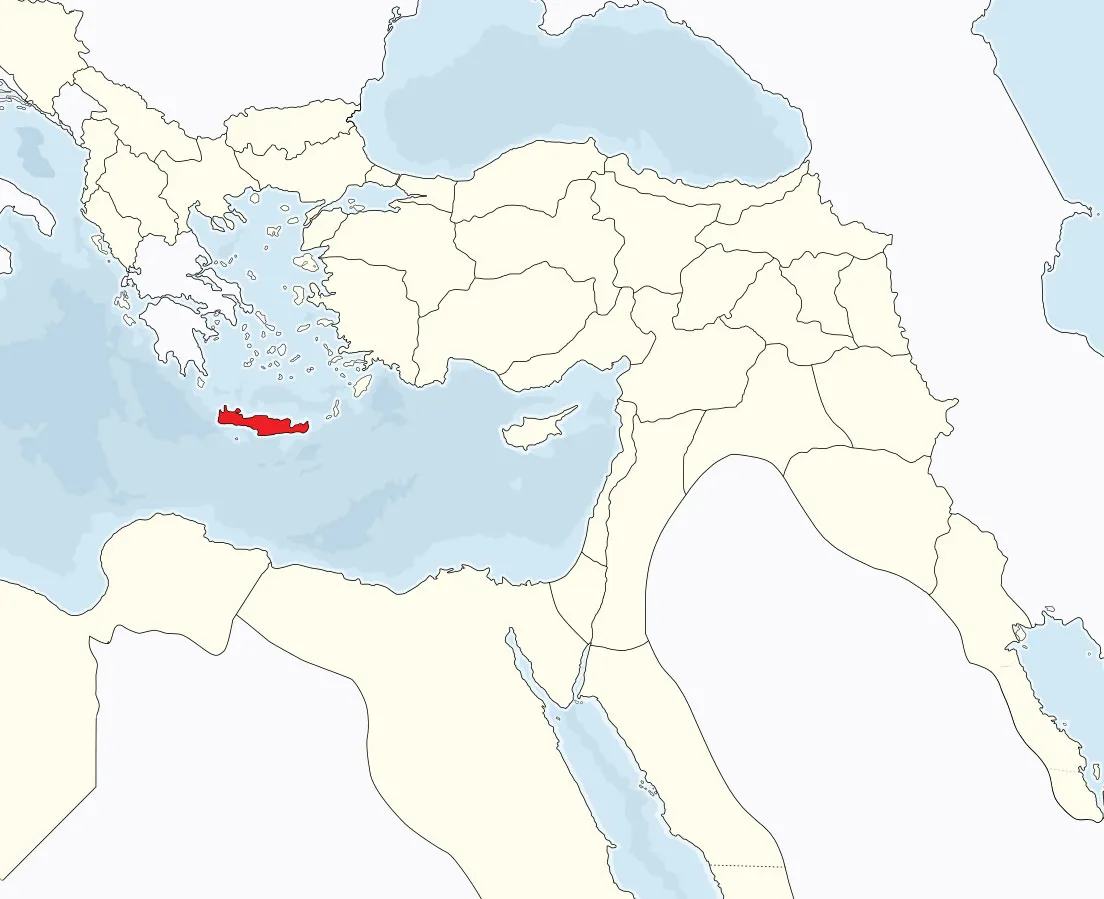An aerial view of Crete, a long mountainous island in the deep blue Mediterranean.